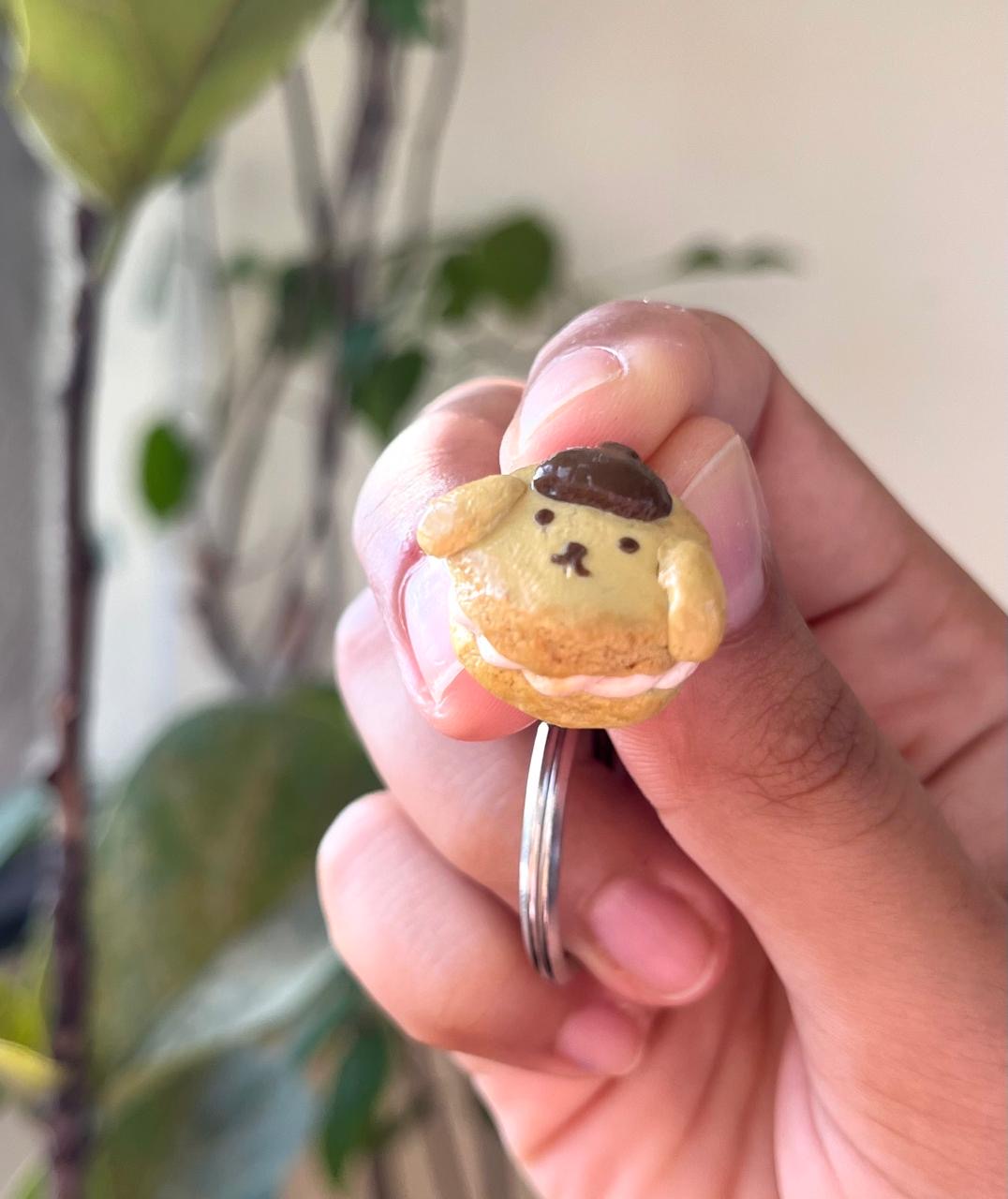 Close-up of a small caramel-coloured character charm