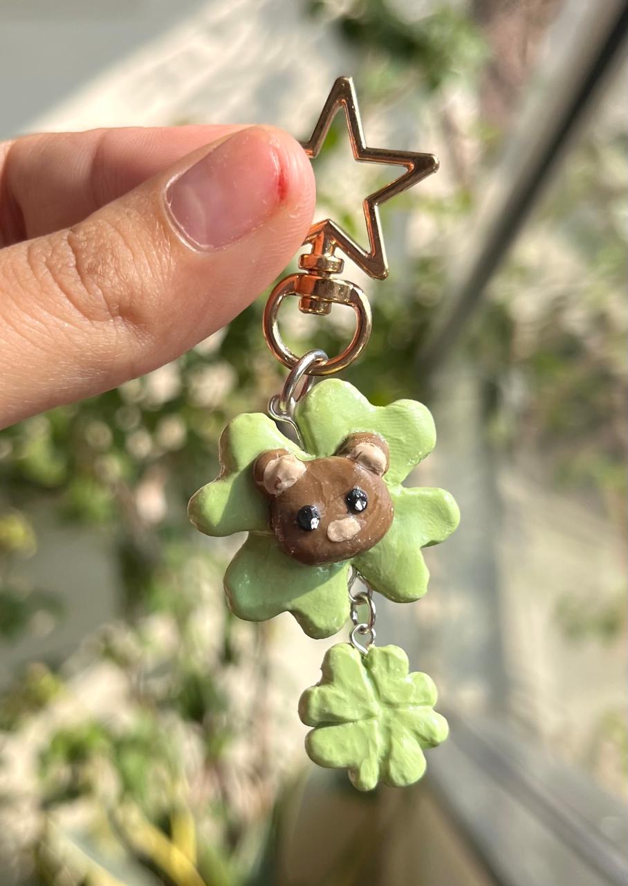 Handmade bear charm in a green four-leaf clover