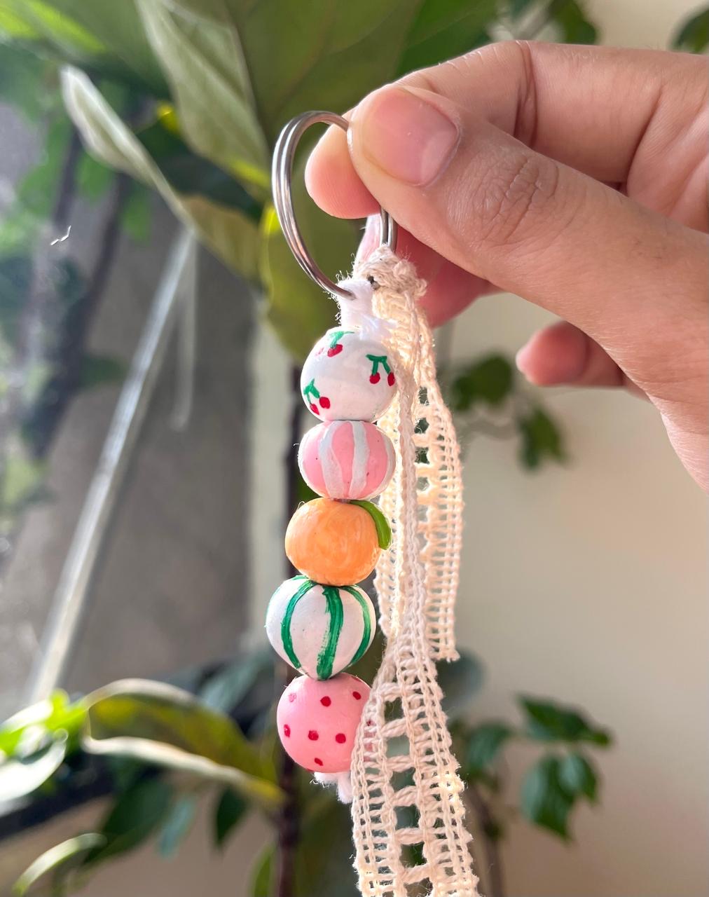 Pastel handmade bead charm with a soft lace detail