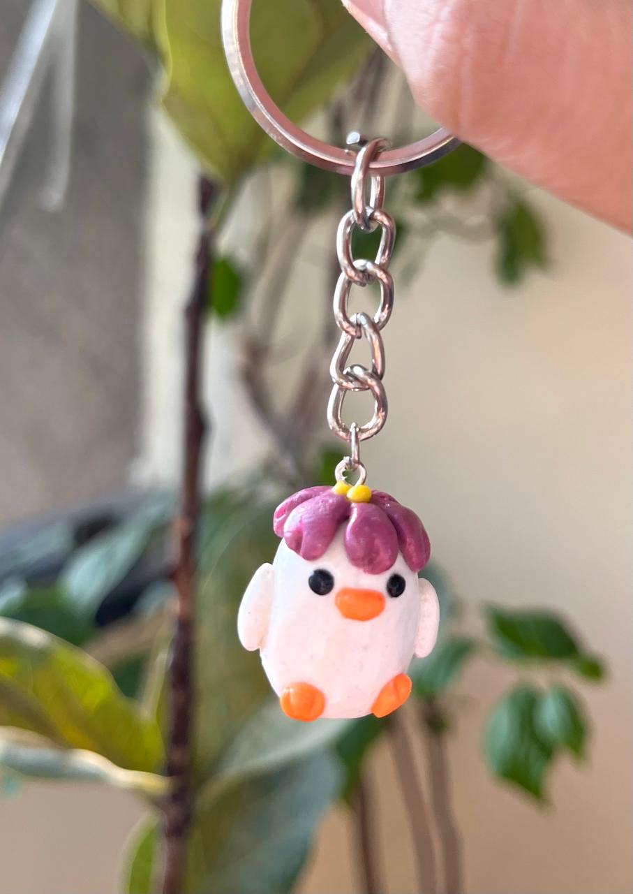White handmade chick keychain with a pink tuft and orange details