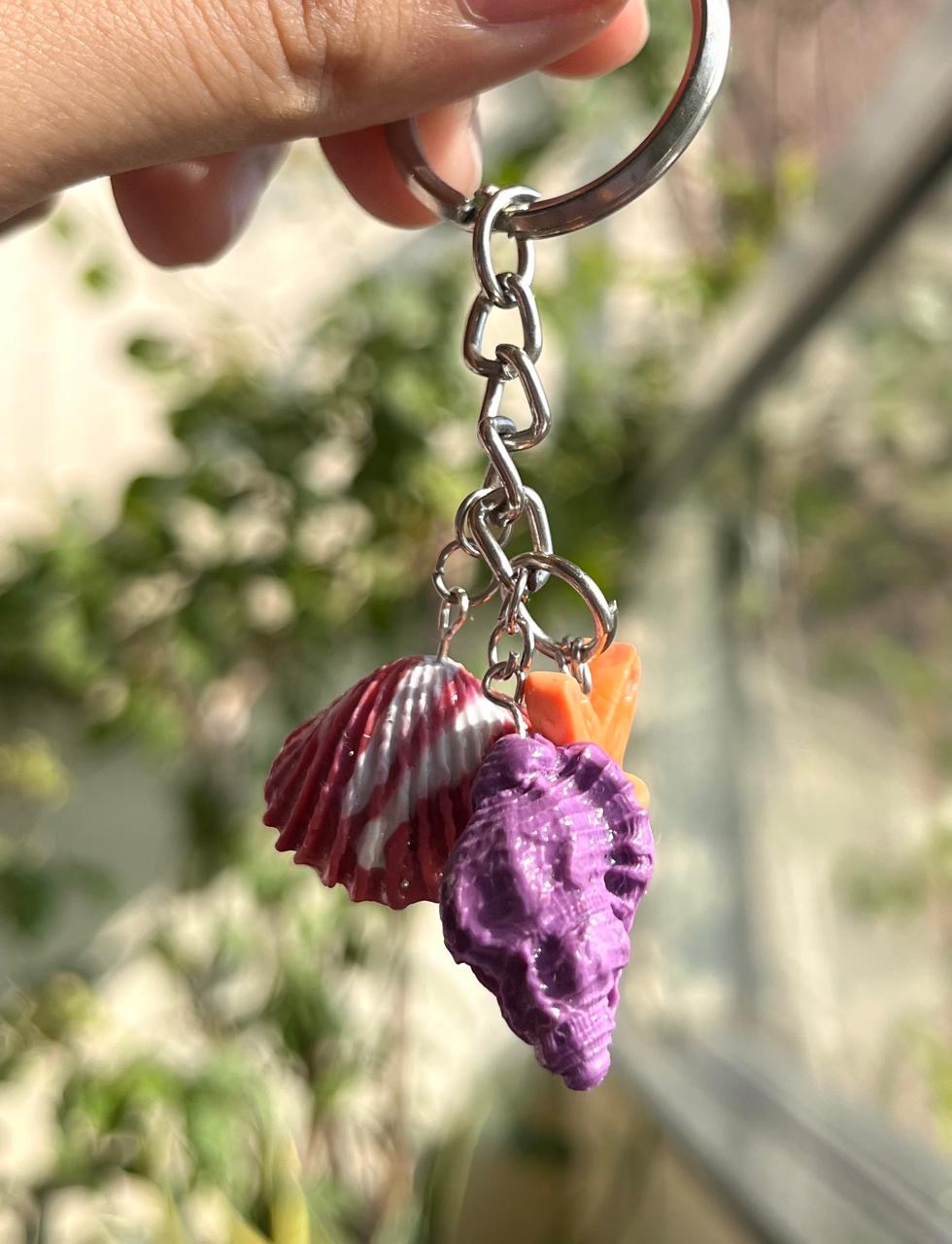 Two colourful miniature seashell charms on a key ring